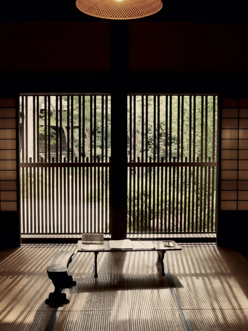 Japanese study room with tatami mats, lit by the garden through wooden lattices